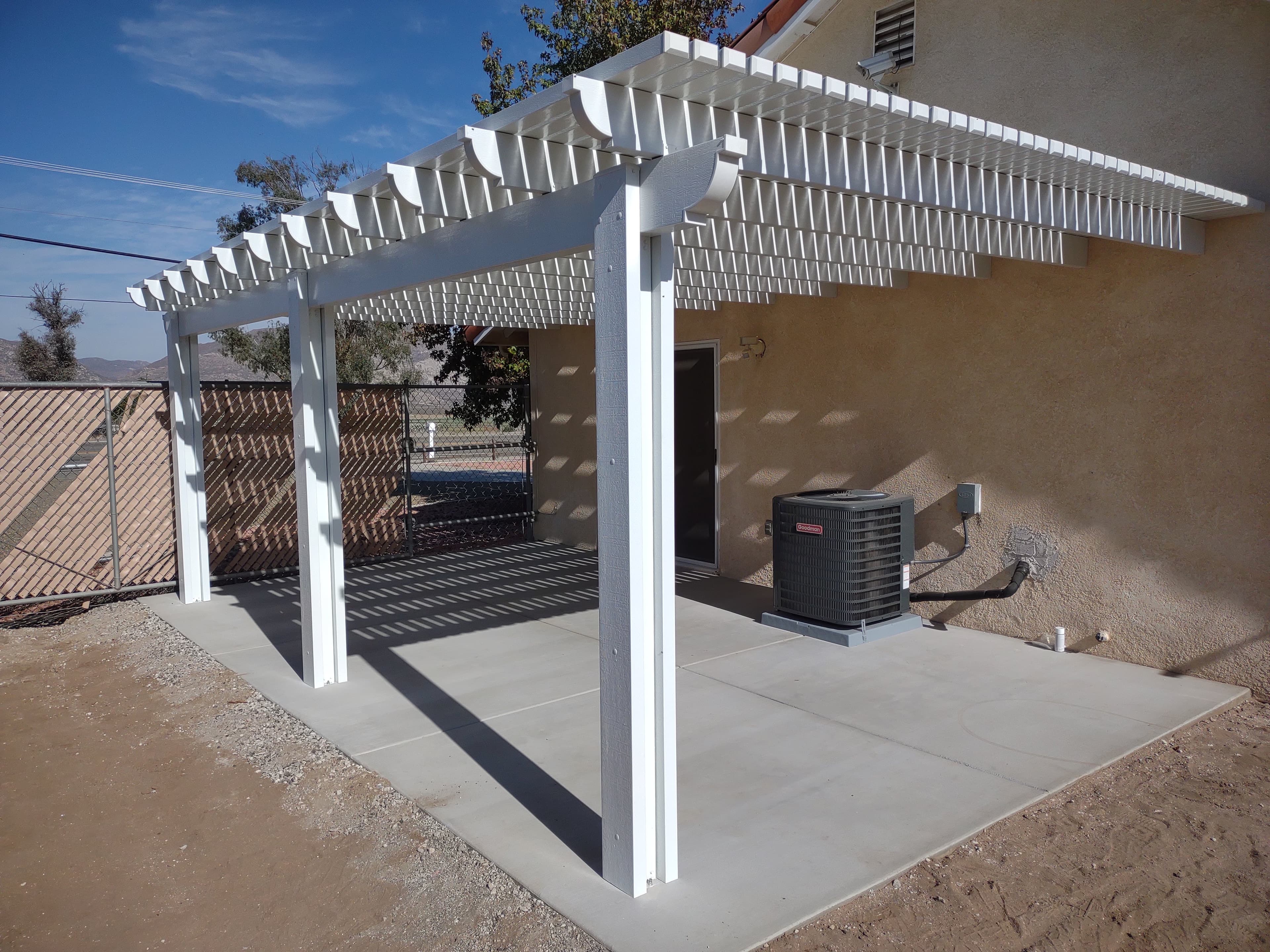 White lattice aluminum patio cover with filtered shade